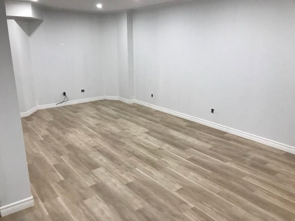 Modern residential flooring installation featuring durable luxury vinyl plank flooring with a professional finish by Phoenix Decks & Contracting in Wasaga Beach, Ontario.